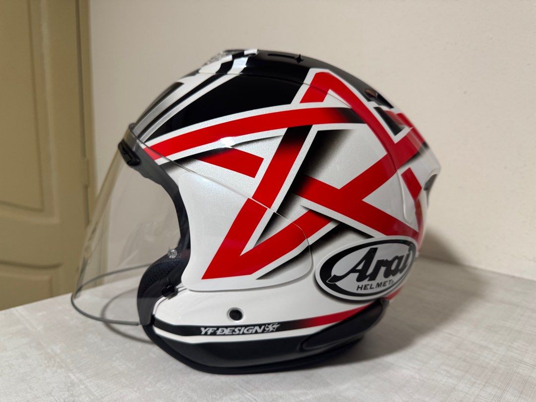 Arai VZ-RAM Helmet with Visor (Category: Motorcycle Apparel) located in Singapore. Submitted by one9eight9 (Listing ID 1445247671, Image 2). Description: - Arai VZ-RAM Helmet Nakano Star - Colour: White with Red & Black Graphic Design - Visor: Clear - Branding: YF DESIGN, Racing Specialities (on bag) - Origin: Made in Japan - wear it for two occasions - Ideal for riders I can deliver it to you with a cost depending on your location .