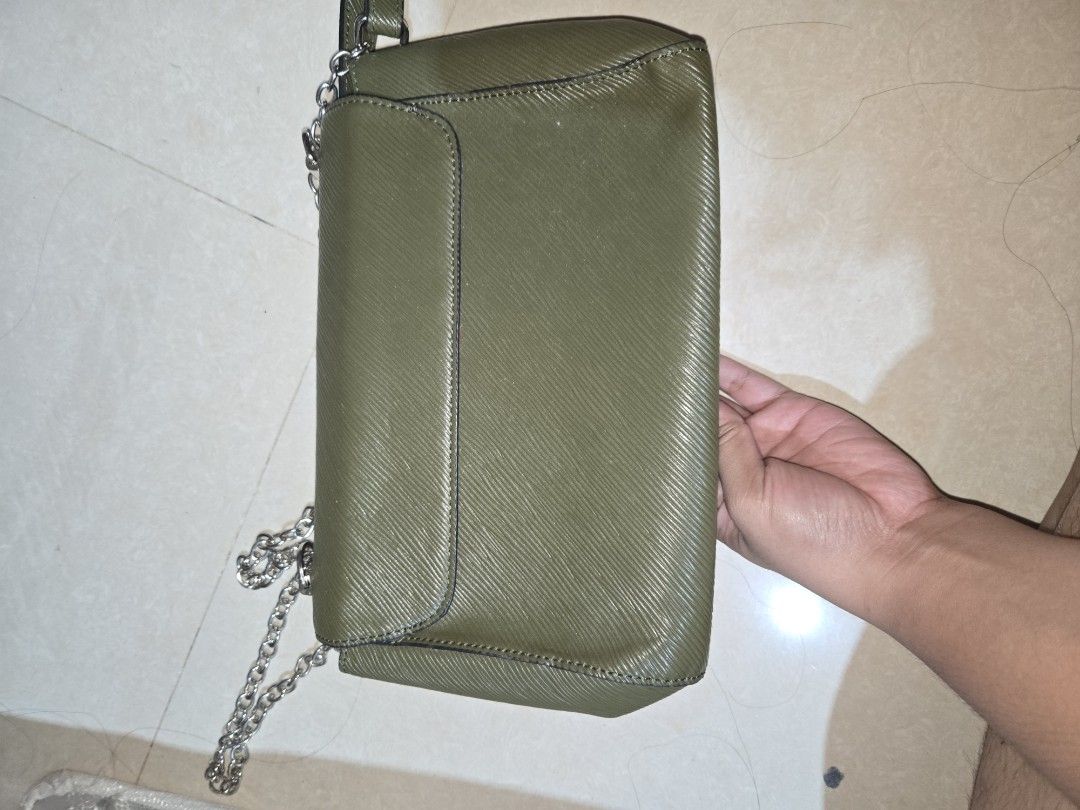 Army Green Sling and Shoulder Bag (Category: Cross-body Bags) located in Tarlac. Submitted by jelly_thrift (Listing ID 1445399534, Image 3). Description: - Khaki green shoulder bag - Silver chain strap - Iconic vl logo on the front - Luxurious red interior - "Made in France" - Ideal size for carrying your essentials.