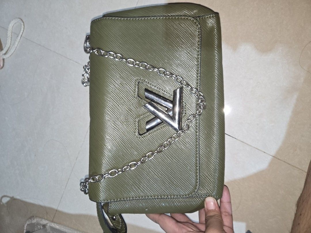 Army Green Sling and Shoulder Bag (Category: Cross-body Bags) located in Tarlac. Submitted by jelly_thrift (Listing ID 1445399534, Image 2). Description: - Khaki green shoulder bag - Silver chain strap - Iconic vl logo on the front - Luxurious red interior - "Made in France" - Ideal size for carrying your essentials.