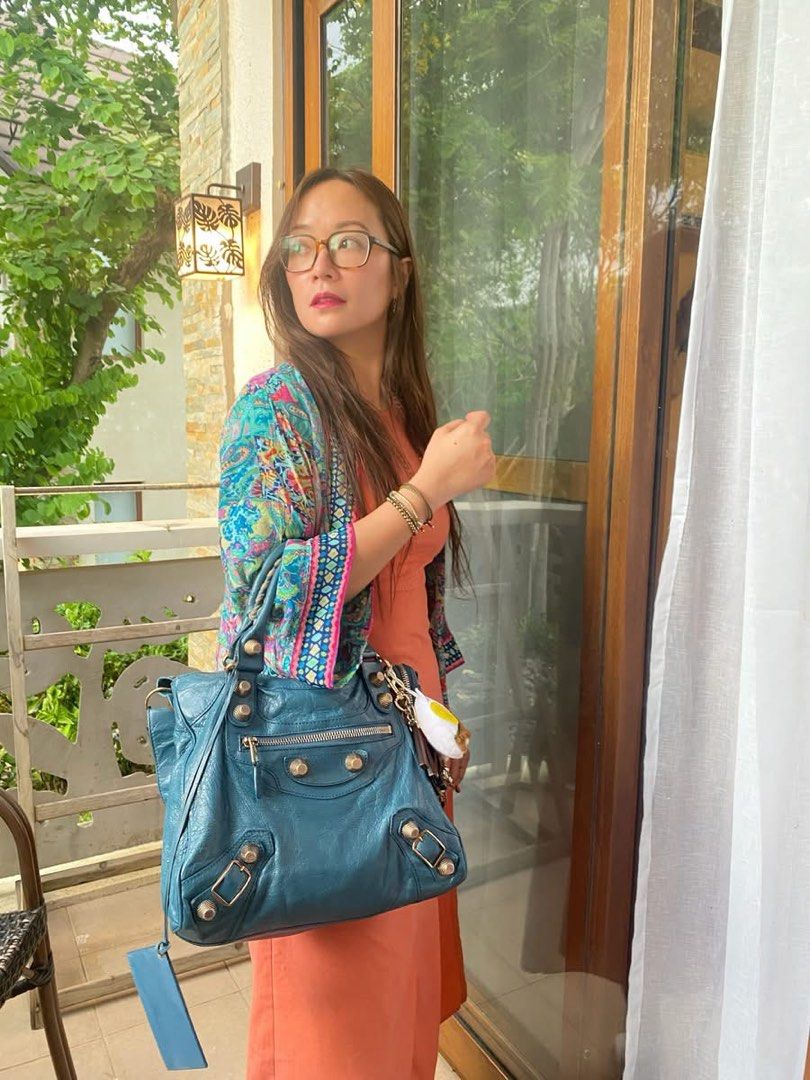 Authentic Balenciaga Blue Giant 21 Velo (Category: Luxury Bags & Wallets) located in Angeles City. Submitted by graiqs (Listing ID 1445398520, Image 2). Description: - Authentic Blue Balenciaga City bag - Made from distressed leather, - Corners of the bag were retouched only due to fading not rubs - selling low due to normal signs of use - overall very pretty - Signature metal studs and buckles - Detachable shoulder strap included - Comes with or