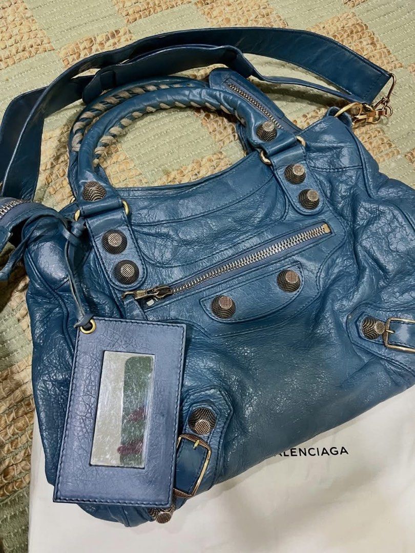 Authentic Balenciaga Blue Giant 21 Velo (Category: Luxury Bags & Wallets) located in Angeles City. Submitted by graiqs (Listing ID 1445398520, Image 3). Description: - Authentic Blue Balenciaga City bag - Made from distressed leather, - Corners of the bag were retouched only due to fading not rubs - selling low due to normal signs of use - overall very pretty - Signature metal studs and buckles - Detachable shoulder strap included - Comes with or