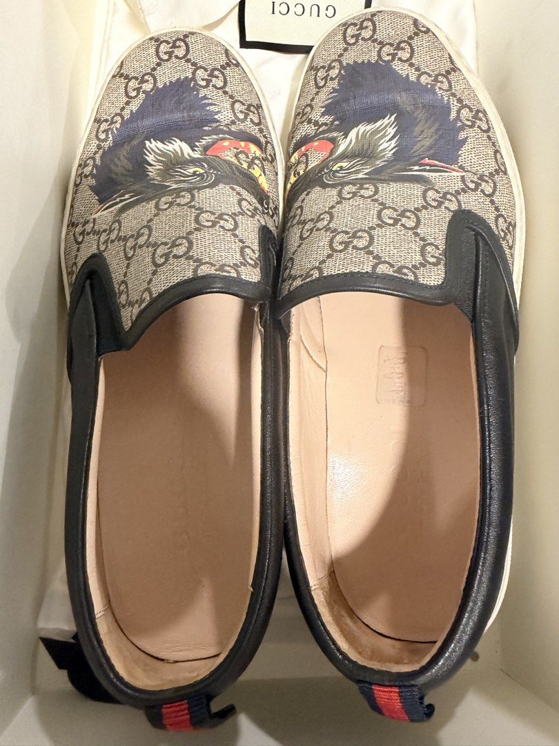Authentic Gucci GG Supreme Wolf Slip-On Sneakers (Category: Sneakers) located in Manila. Submitted by denkim (Listing ID 1445250808, Image 1). Description: - Authentic Gucci GG Supreme canvas slip-on sneakers - Features iconic GG pattern with a wolf graphic - Leather trim and sole - Made in Italy - Comes with original box and dust bag.