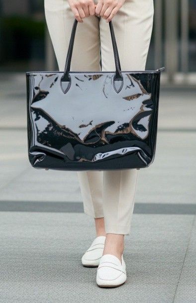 AUTHENTIC PRELOVED Uniqlo x Ines de la Fressange Black Patent Tote Bag (Category: Tote Bags) located in Johor Bahru. Submitted by zadazempire (Listing ID 1445302011, Image 1). Description: - Uniqlo x Ines de la Fressange collaboration - Black patent leather look - Shiny finish - Zippered closure for security - Interior pockets for organization - Sturdy, comfortable handles - Ideal for everyday errands or professional settings.