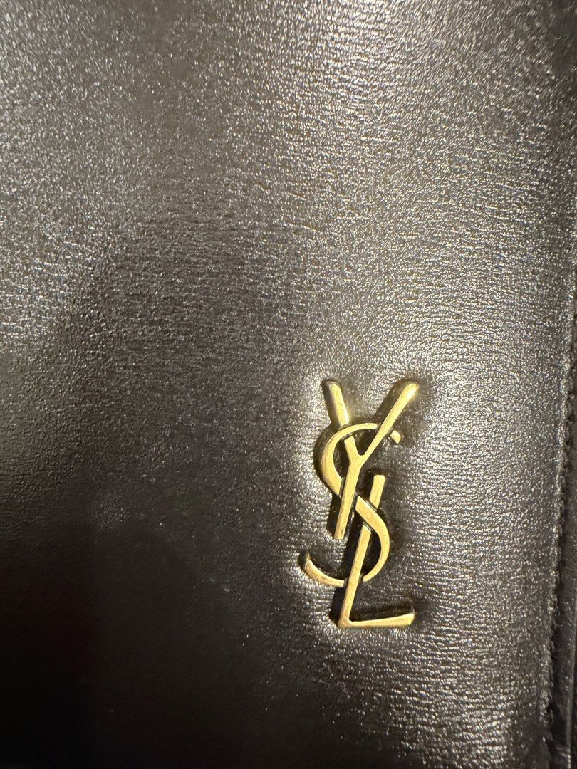 Authentic Saint Laurent YSL Black Leather Pouch Clutch (Category: Luxury Bags & Wallets) located in Manila. Submitted by denkim (Listing ID 1445250653, Image 2). Description: - Authentic Saint Laurent pouch - Material: Black leather - Hardware: Gold-tone iconic YSL logo - Closure: Zip with branded pull - Interior: Card slots and compartments - Includes: Dust bag and authenticity cards - Versatile use: Organizing essentials or as a standalone clut