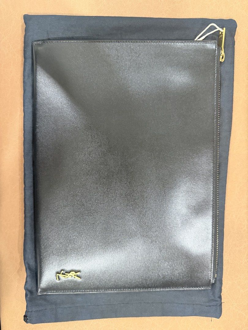 Authentic Saint Laurent YSL Black Leather Pouch Clutch (Category: Luxury Bags & Wallets) located in Manila. Submitted by denkim (Listing ID 1445250653, Image 1). Description: - Authentic Saint Laurent pouch - Material: Black leather - Hardware: Gold-tone iconic YSL logo - Closure: Zip with branded pull - Interior: Card slots and compartments - Includes: Dust bag and authenticity cards - Versatile use: Organizing essentials or as a standalone clut