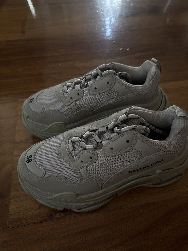 Balenciaga Triple S Sneakers Size 38 (Category: Sneakers) located in Pasig City. Submitted by npl123 (Listing ID 1445301608, Image 1). Description: - Balenciaga Triple S Sneakers - Color: Light Beige - Size: 38 - Features: Iconic chunky design, signature layered sole - Branding: Balenciaga logo on side and sole - Detail: Size '38' visible on toe box - Style: Ideal for everyday wear.