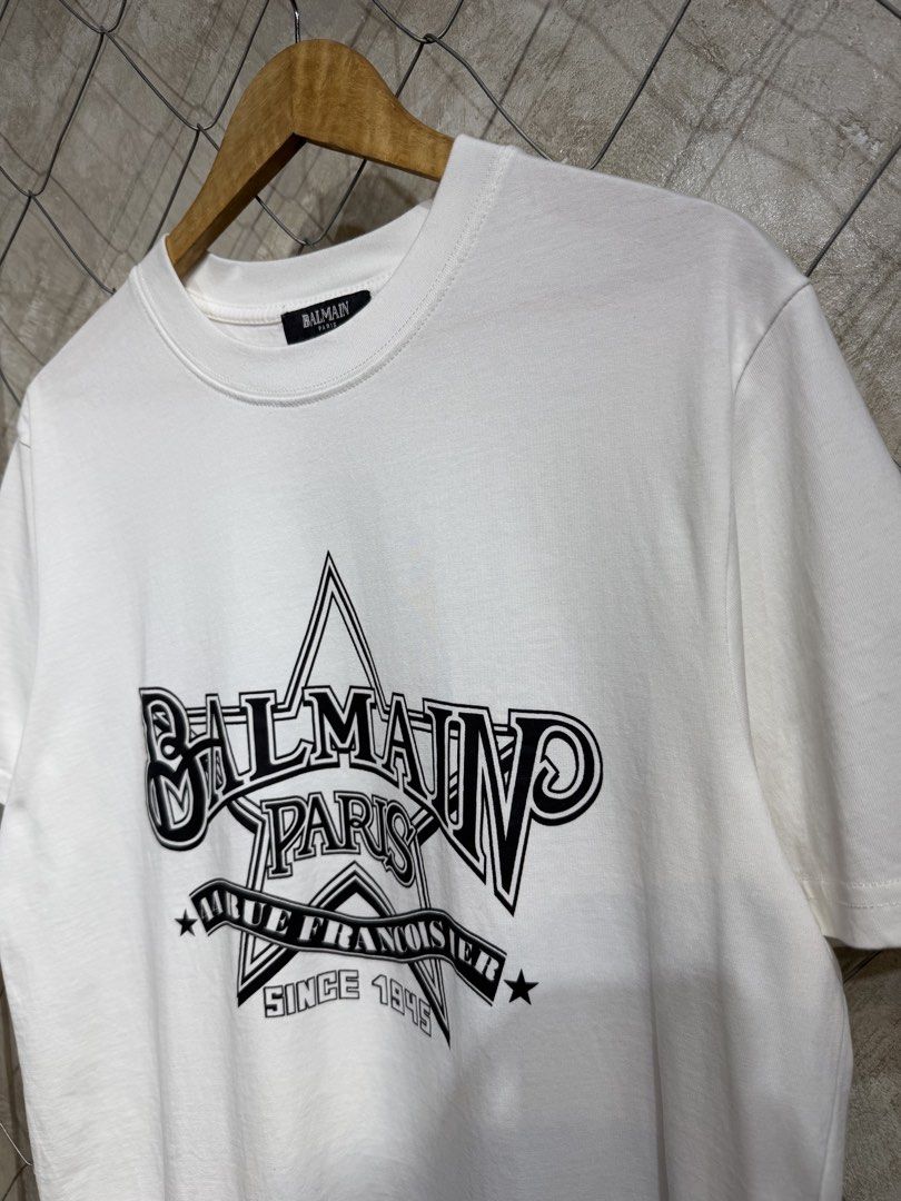 Balmain Paris T-Shirt White (Category: Tshirts & Polo Shirts ) located in Manila. Submitted by ardobe.mnl (Listing ID 1445371823, Image 3). Description: Balmain Star Logo White Tee. Size: Large Dimes: 22x29 Condition: Good asnew Flaw: None! Dm for more inquiries! 😇.