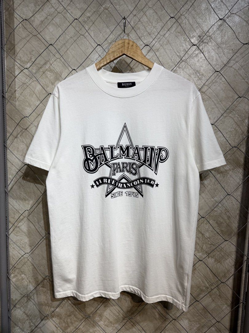 Balmain Paris T-Shirt White (Category: Tshirts & Polo Shirts ) located in Manila. Submitted by ardobe.mnl (Listing ID 1445371823, Image 1). Description: Balmain Star Logo White Tee. Size: Large Dimes: 22x29 Condition: Good asnew Flaw: None! Dm for more inquiries! 😇.