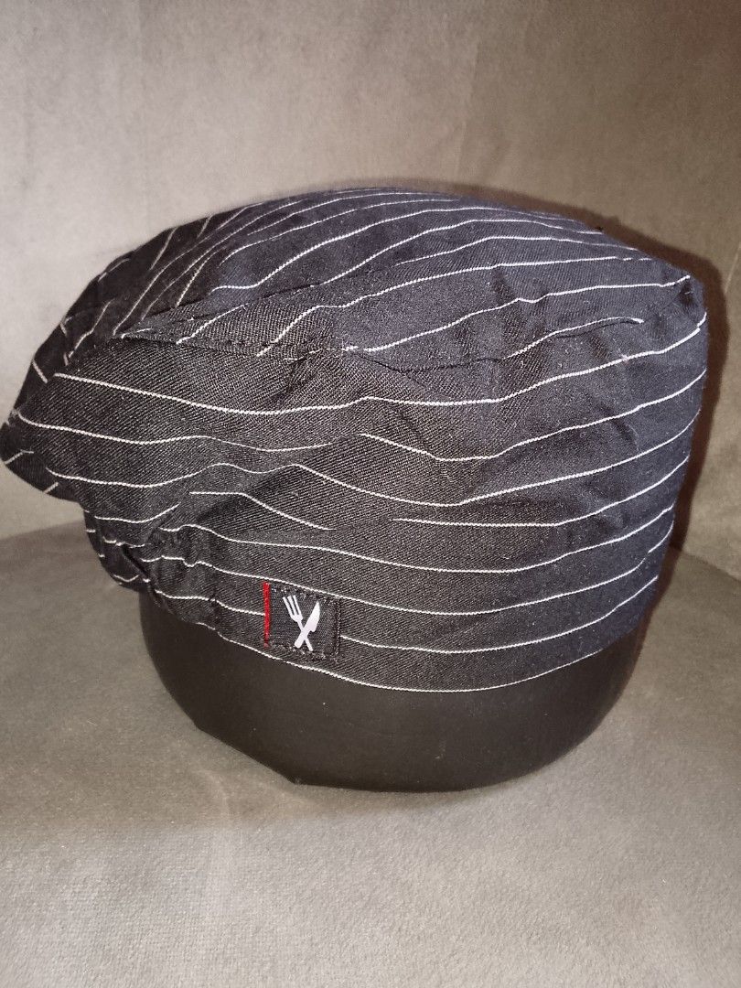 Black Pinstripe Chef Hat with Fork and Knife Logo (Category: Caps & Hats) located in Binangonan. Submitted by yuristalin888 (Listing ID 1445245747, Image 3). Description: - Stylish black chef hat with subtle white pinstripes. - Features a small embroidered fork and knife logo on the side. - Elasticated back ensures a comfortable and secure fit for all sizes. - Ideal for culinary professionals, aspiring chefs, or themed events. - Designed for easy