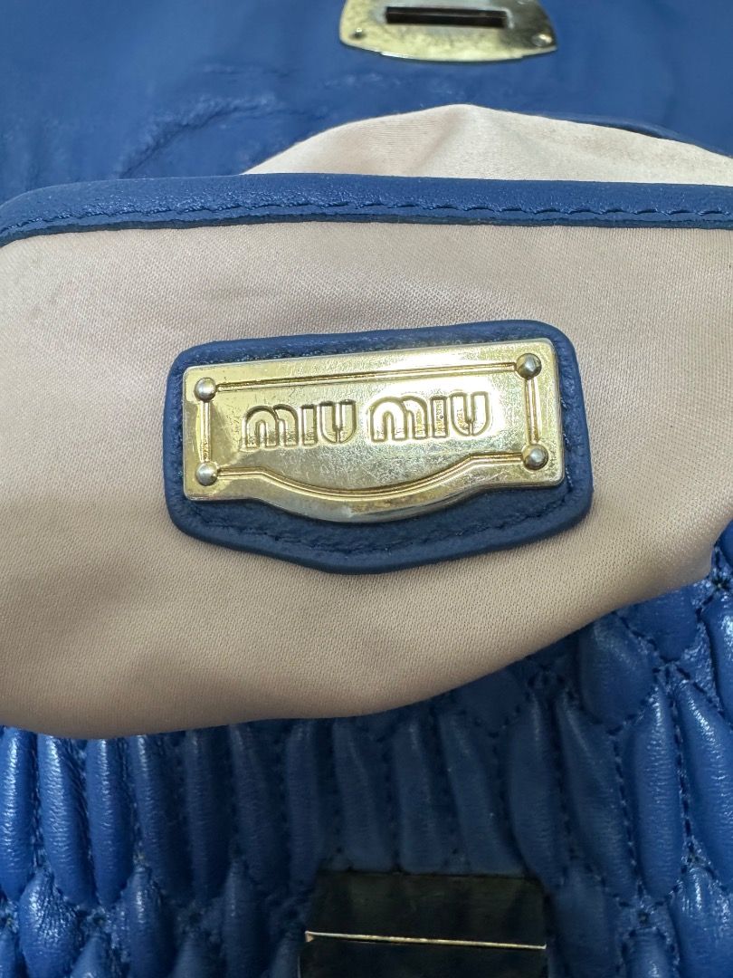 Blue Ruched Leather Handbag with Embellished Clasp (Category: Luxury Bags & Wallets) located in Malolos. Submitted by urban_thrift_09 (Listing ID 1445334411, Image 3). Description: - Navy blue ruched leather handbag - Gold-tone clasp with clear embellishments - Braided leather strap with detachable gold clip .