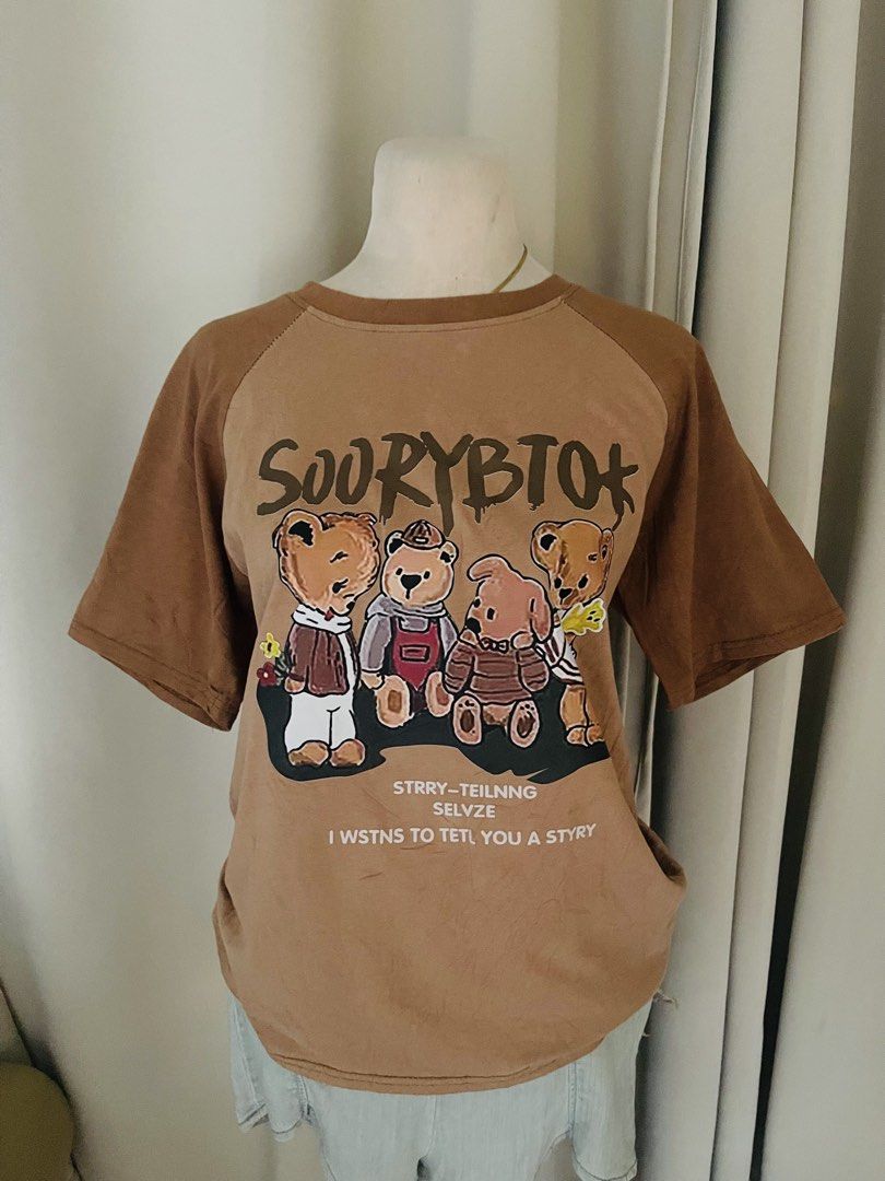 Brown Graphic T-shirt with Bear Print (Category: Shirts) located in Cainta. Submitted by zlove111 (Listing ID 1445415006, Image 1). Description: - Cute brown t-shirt - Features a graphic print of bears - Raglan - Ideal for casual wear - Easily pairs with shorts or jeans small-semilarge 20".