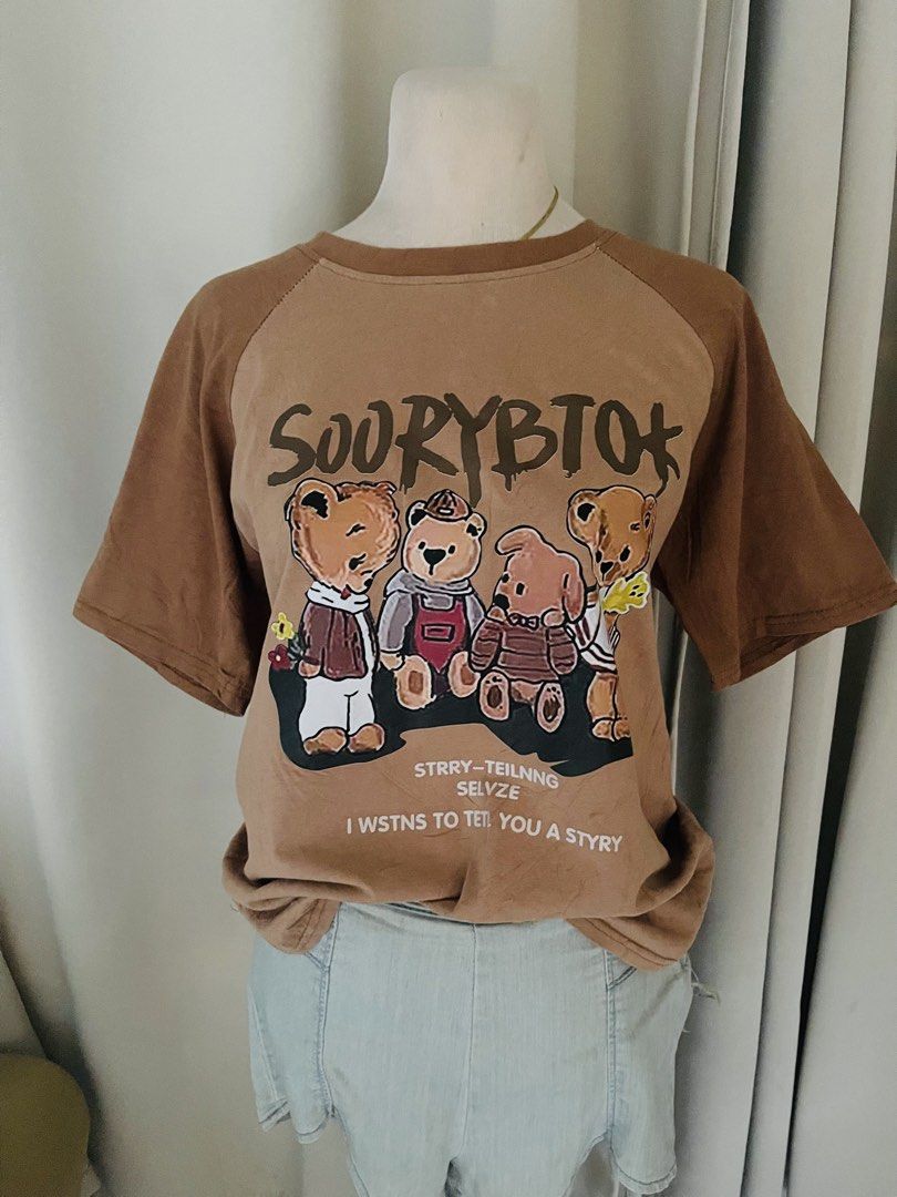 Brown Graphic T-shirt with Bear Print (Category: Shirts) located in Cainta. Submitted by zlove111 (Listing ID 1445415006, Image 2). Description: - Cute brown t-shirt - Features a graphic print of bears - Raglan - Ideal for casual wear - Easily pairs with shorts or jeans small-semilarge 20".