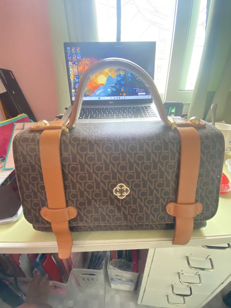 Brown Monogram Handbag with Tan Straps (Category: Luxury Bags & Wallets) located in Imus. Submitted by wheagirl (Listing ID 1445333237, Image 1). Description: - Stylish brown monogram handbag - Tan straps and handle for a classic look - Elegant gold hardware details - Interior includes a zippered compartment and a main compartment - Clean interior, ready for your essentials - Ideal for everyday use and errands.