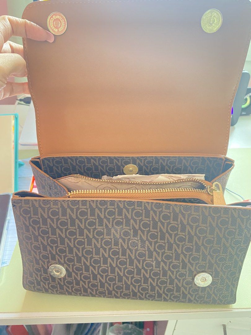 Brown Monogram Handbag with Tan Straps (Category: Luxury Bags & Wallets) located in Imus. Submitted by wheagirl (Listing ID 1445333237, Image 3). Description: - Stylish brown monogram handbag - Tan straps and handle for a classic look - Elegant gold hardware details - Interior includes a zippered compartment and a main compartment - Clean interior, ready for your essentials - Ideal for everyday use and errands.