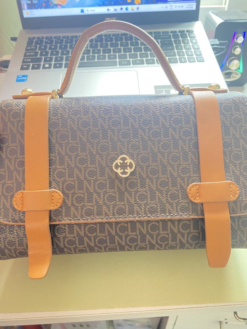 Brown Monogram Handbag with Tan Straps (Category: Luxury Bags & Wallets) located in Imus. Submitted by wheagirl (Listing ID 1445333237, Image 2). Description: - Stylish brown monogram handbag - Tan straps and handle for a classic look - Elegant gold hardware details - Interior includes a zippered compartment and a main compartment - Clean interior, ready for your essentials - Ideal for everyday use and errands.