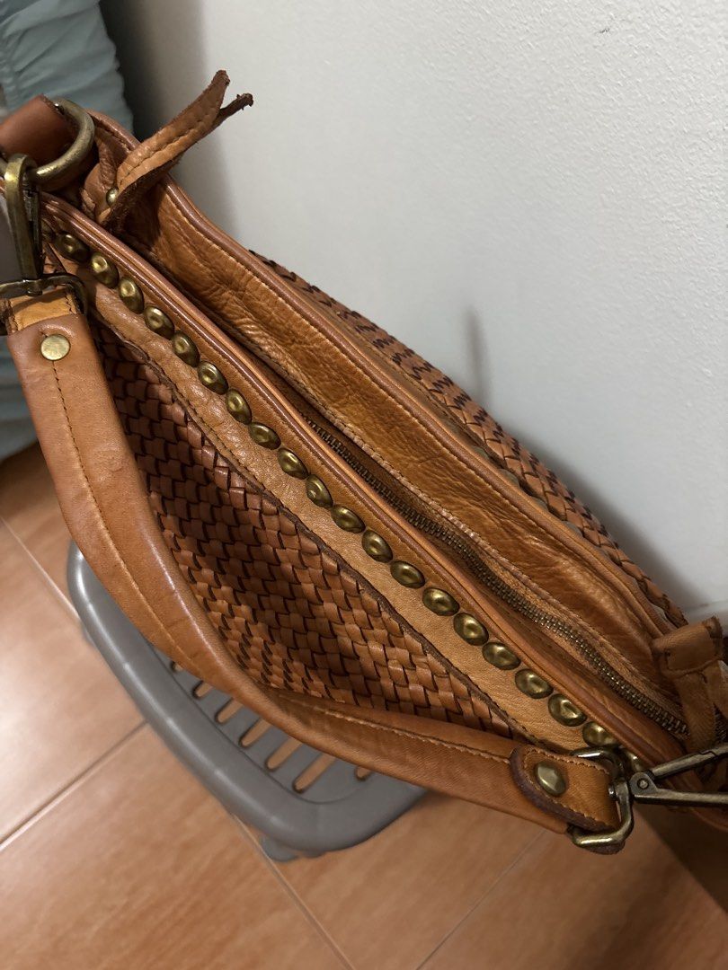 Brown Woven Leather Studded Shoulder Bag (Category: Shoulder Bags) located in Manila. Submitted by pugo_08_08_08 (Listing ID 1445251524, Image 3). Description: - Stylish cool brown woven leather bag - Features decorative studs along top and bottom edges - Secure zipper closure - Durable leather straps - Spacious interior for all your essentials - Ideal for everyday use.