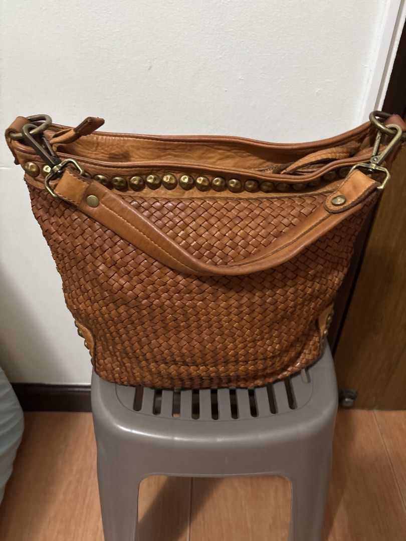Brown Woven Leather Studded Shoulder Bag (Category: Shoulder Bags) located in Manila. Submitted by pugo_08_08_08 (Listing ID 1445251524, Image 1). Description: - Stylish cool brown woven leather bag - Features decorative studs along top and bottom edges - Secure zipper closure - Durable leather straps - Spacious interior for all your essentials - Ideal for everyday use.
