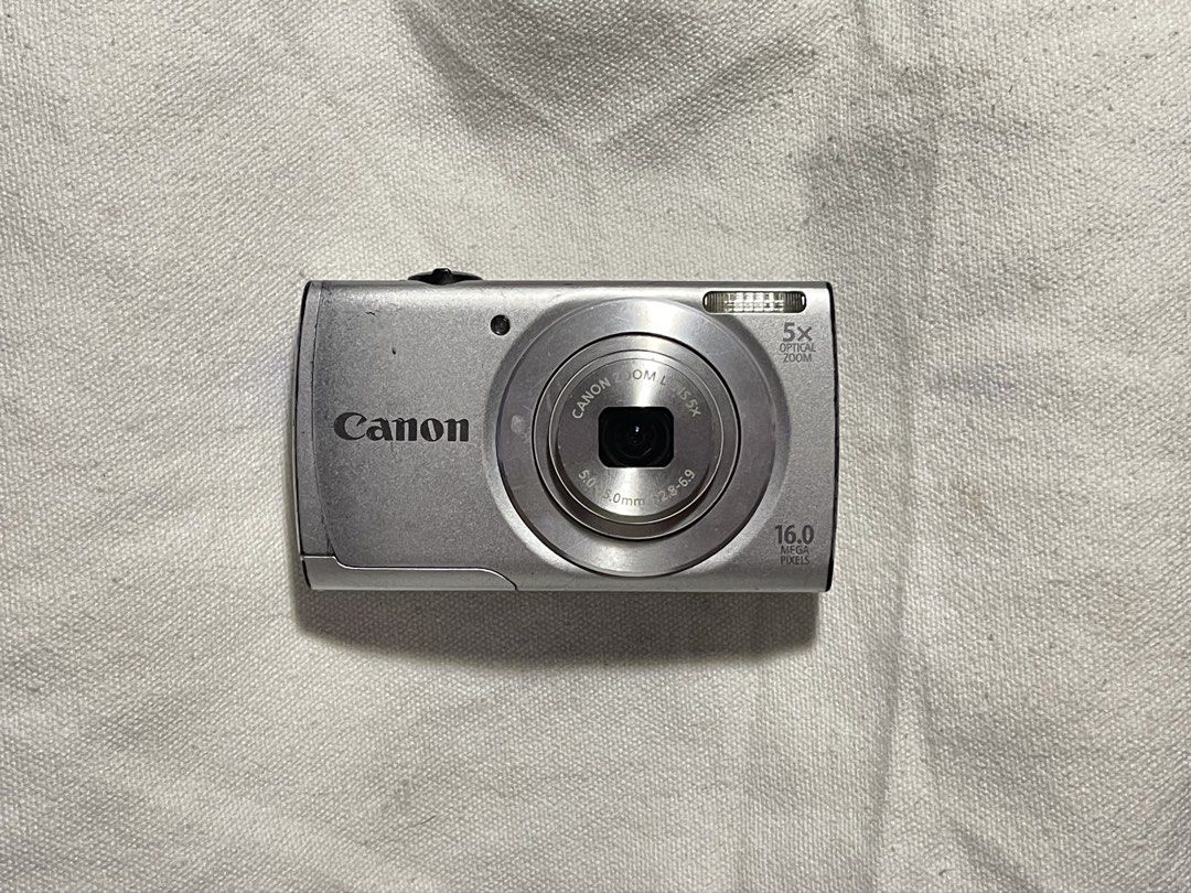 Canon PowerShot A2500 Digital Camera (For Repair) (Category: Cameras) located in Liliw. Submitted by j444mes (Listing ID 1445338393, Image 1). Description: - Silver Canon PowerShot A2500 digital camera - 16.0 Megapixels for clear photos - 5x Optical Zoom to get closer to your subject - Please review all photos carefully to assess the item's condition. issue: - “Lens Error Will shut down immediately” - for repair inclusions: battery sd card charge