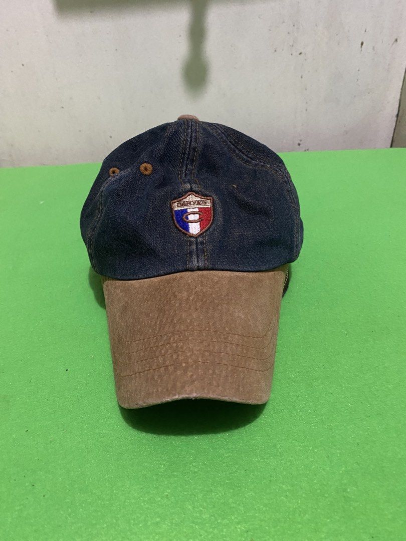 Carven Jeans Denim & Suede Baseball Cap (Category: Caps & Hats) located in Manila. Submitted by resi.diaz (Listing ID 1445399060, Image 1). Description: - Stylish Carven Jeans cap - Dark denim with a brown suede brim - Features the iconic Carven logo on the front - 'CARVEN JEANS' embroidered on the back - Adjustable strap with a buckle closure for a perfect fit - Ideal for adding a cool touch to your casual outfits.