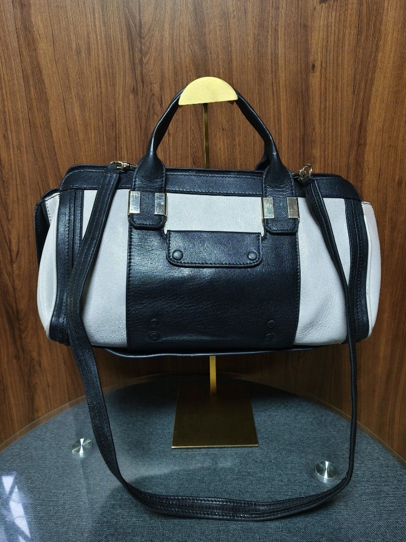 CHLOÉ-INSP. TWO-TONE SATCHEL (Category: Tote Bags) located in Baguio. Submitted by PreiLoveMaria (Listing ID 1445342855, Image 2). Description: CHLOÉ-INSP. TWO-TONE SATCHEL 🖤 This piece features the exact iconic silhouette, colorblock paneling, and winged-side design as the famous Chloé Alice Bag. It relies entirely on its striking, minimalist structure rather than loud logos to make a statement. Please note: This is an unbranded, inspired piece