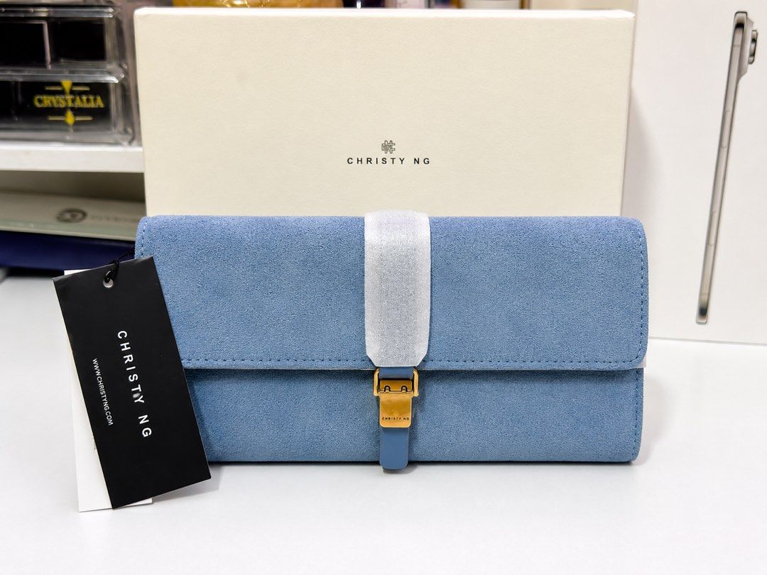 Christy Ng Malia Long Wallet (Category: Luxury Bags & Wallets) located in Manila. Submitted by cjonlineshop.10 (Listing ID 1419740898, Image 1). Description: - Suede clutch wallet - Available in brown and blue - Secure strap closure - Gold-colored buckle - Soft, suede-like material - Perfect for carrying essentials.