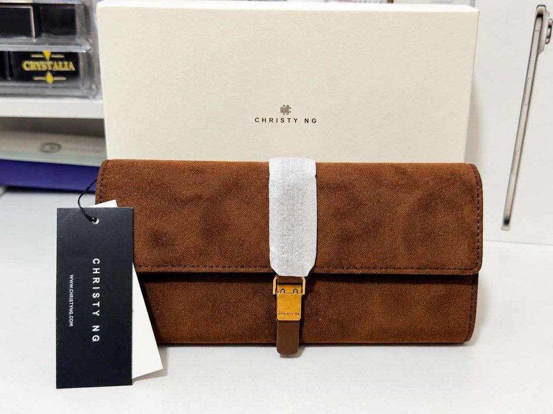 Christy Ng Malia Long Wallet (Category: Luxury Bags & Wallets) located in Manila. Submitted by cjonlineshop.10 (Listing ID 1419740898, Image 2). Description: - Suede clutch wallet - Available in brown and blue - Secure strap closure - Gold-colored buckle - Soft, suede-like material - Perfect for carrying essentials.