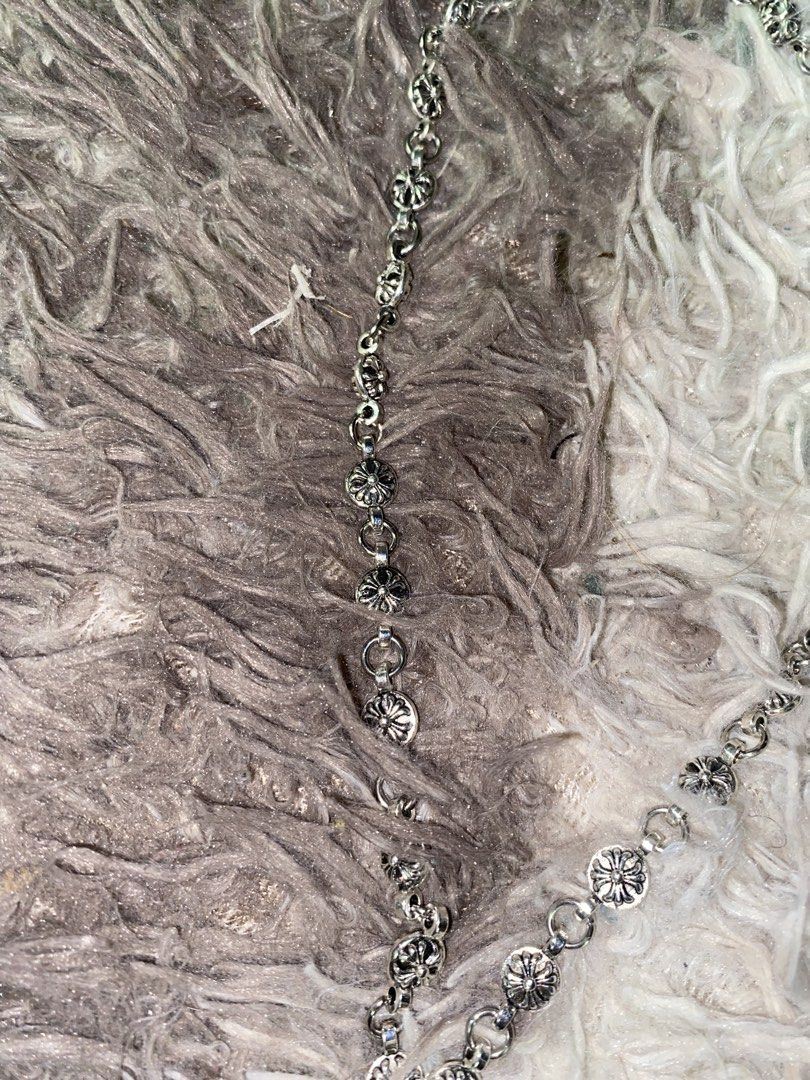 Chrome Hearts Cross Necklace (Category: Necklaces) located in Caloocan City. Submitted by remythrift (Listing ID 1445261747, Image 3). Description: - Authentic Chrome Hearts necklace - Iconic cross pendant with intricate detailing - Silver chain with small cross charms - Engraved with 'Chrome Hearts' and '1999' - Perfect statement piece for an edgy look.