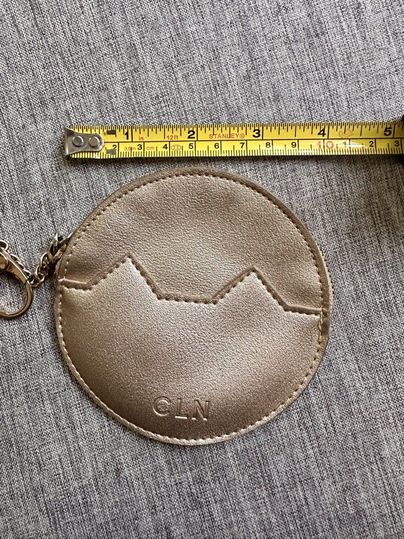 CLN Rose Gold Round Coin Pouch Keychain (Category: Purses & Pouches) located in Quezon City. Submitted by k_prelovedpieces (Listing ID 1445273655, Image 2). Description: - Cute round coin pouch from CLN - Rose gold color with a stylish zig-zag design - Features an attached keychain for easy carrying - Measures approximately 4 inches across - Ideal for organizing small essentials like coins, keys, or earbuds.