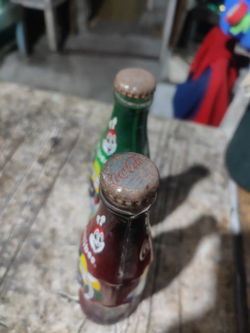 Coca-Cola Bottles - University Athletic Association 1938 (Category: Vintage Collectibles) located in Manila. Submitted by richardestano (Listing ID 1445346687, Image 3). Description: - Set of 2 Coca-Cola bottles (1 red, 1 green) - Features University Athletic Association 1938 design - Ideal for collectors - Caps show some rust.