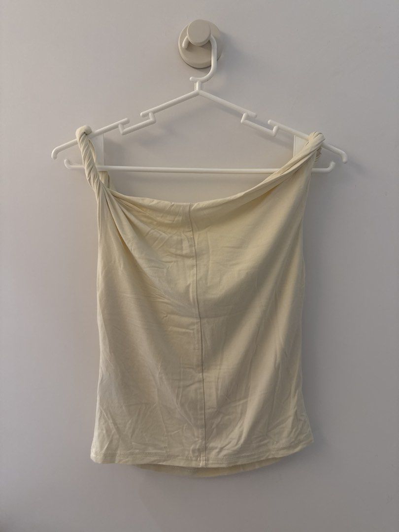 Cream Cowl Neck Twisted Strap Tank Top (Category: Sleeveless) located in Manila. Submitted by chen.854 (Listing ID 1445381091, Image 2). Description: - Cream colored tank top - Features a cowl neckline - Twisted straps at the shoulders - Sleeveless design - Made from a soft, stretchy material - Versatile for layering or wearing on its own - Simple and chic style.