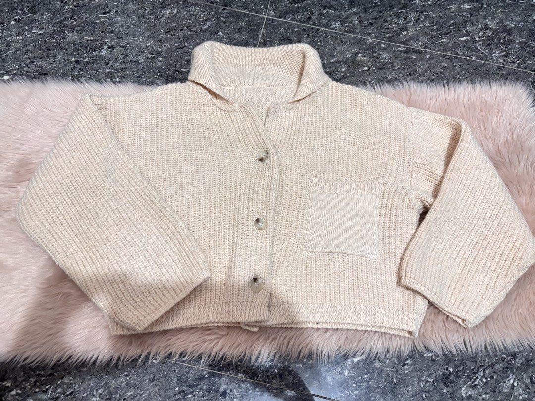 Cream Knit Button-Up Cardigan with Pocket (Category: Coats, Jackets and Outerwear) located in Valenzuela. Submitted by wonwon99 (Listing ID 1445383943, Image 1). Description: - Cream colored knit cardigan - Features a collar and button-up front - Left chest pocket - Cropped length - Cozy and warm, ideal for layering.