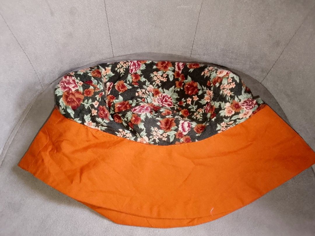 Floral Bucket Hat with Orange Brim (Category: Hats & Beanies) located in Binangonan. Submitted by yuristalin888 (Listing ID 1445245215, Image 3). Description: - Cute bucket hat with a dark floral print. - Features a vibrant bright orange brim. - Ideal for sunny days and outdoor activities. - Adds a stylish pop of color to any outfit. - Lightweight and easy to pack for travel..
