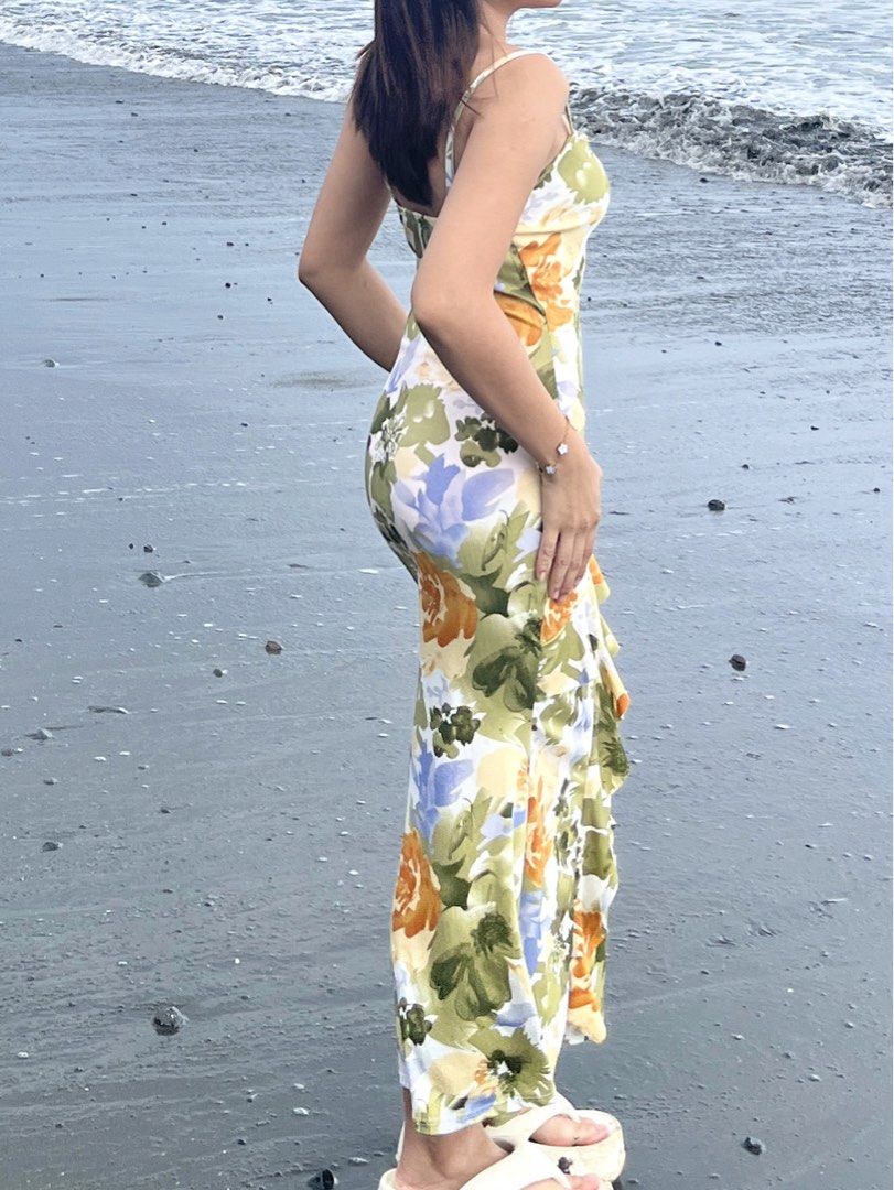 Floral Print Ruffle Maxi Dress (Category: Dresses) located in Rizal. Submitted by chezcaaphrodite (Listing ID 1445271116, Image 3). Description: - Color: Green - Size: Small to Medium - Flowy maxi dress with a vibrant floral print - Flattering silhouette with side ruffle details - Spaghetti straps for warm weather comfort - Ideal for beach days and summer parties - Easy to wear and comfortable.