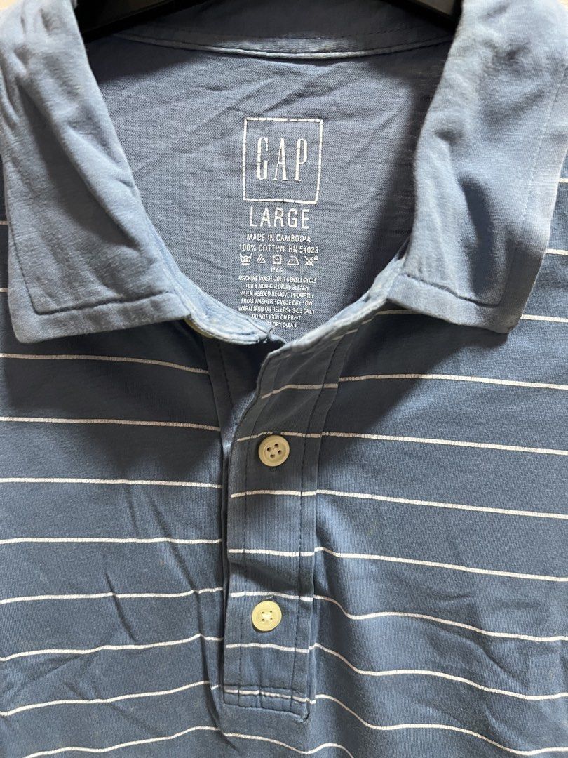 GAP Blue Striped Polo Shirt - Size Large (Category: Tshirts & Polo Shirts ) located in Cainta. Submitted by p3spreloved (Listing ID 1445336678, Image 2). Description: - Classic blue polo shirt from GAP - Features thin white horizontal stripes - Short sleeves with a two-button placket - Made of 100% breathable cotton - Ideal for casual or smart-casual styling Length 30in Width 22.5in.