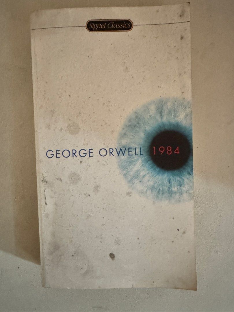 George Orwell 1984 (Category: Storybooks) located in Quezon City. Submitted by harristhegoldenboy (Listing ID 1445236307, Image 1). Description: - Title: George Orwell 1984 - Edition: Signet Classics - Genre: Dystopian Fiction - Condition: Used, with visible signs of age on pages and cover, adding to its vintage charm. - Features: Thought-provoking narrative, a must-have for classic literature enthusiasts. RFS Decluttering. Negotiable.