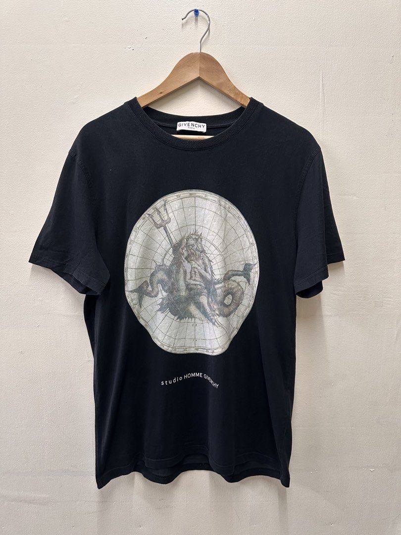 Givenchy Paris Studio Homme T-Shirt (Category: Tshirts & Polo Shirts ) located in Manila. Submitted by rashidgaddi (Listing ID 1445253529, Image 1). Description: - Black Givenchy Paris T-shirt - Features a striking Poseidon graphic print on both front and back - The graphic has a vintage, map-like aesthetic - Text below the graphic reads 'studio HOMME GIVENCHY' - A classic and iconic piece from Givenchy.