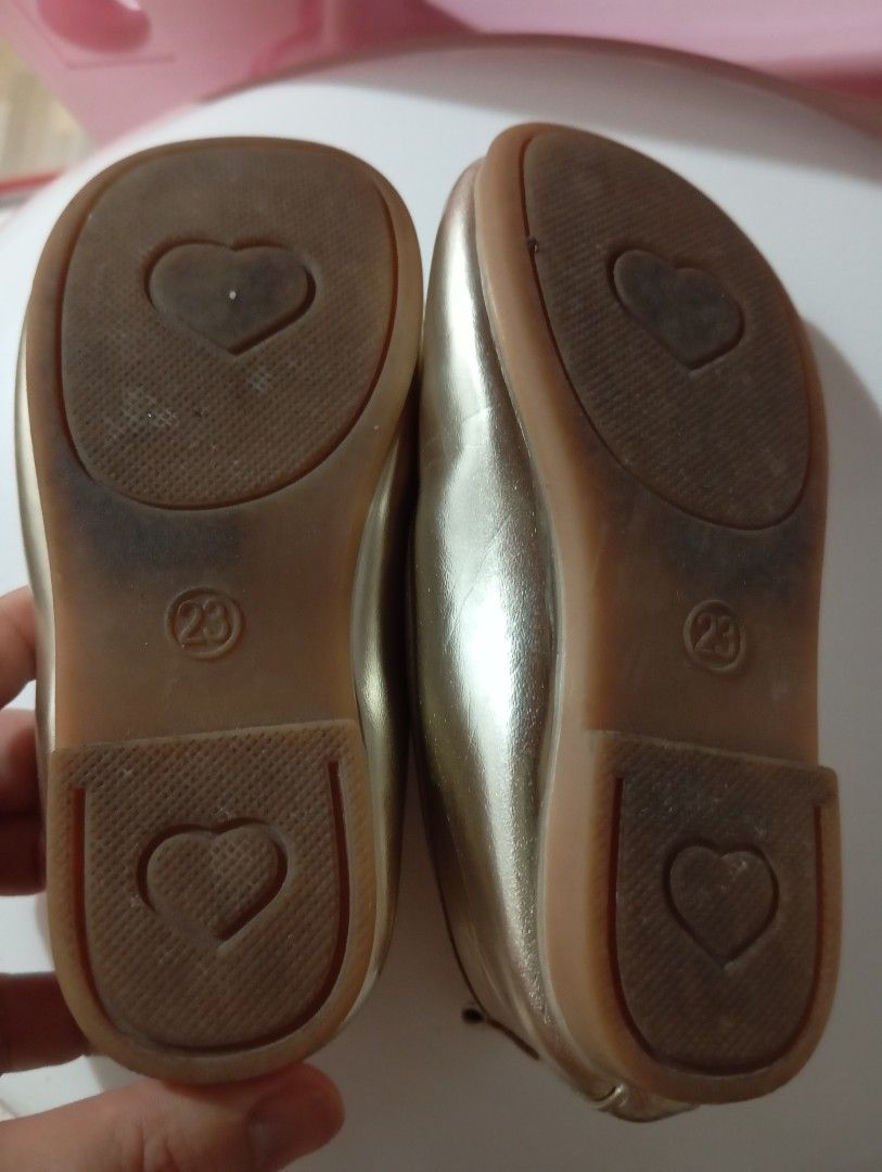 Gold Ballet Flats with Bows - Size 23 (Category: Babies & Kids Fashion) located in Manila. Submitted by brion123 (Listing ID 1445252361, Image 2). Description: - size 23 Adorable gold ballet flats for little girls. - Sweet bow detail on the front. - Secure strap for a comfortable fit. - Cute heart detail on the sole. - Size: 23 - Ideal for parties, special occasions, or everyday wear..