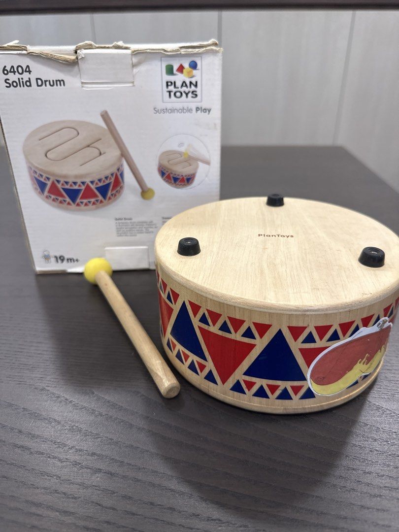 Good Condition Solid Drum (Category: Infant Playtime) located in Singapore. Submitted by sigur_ros (Listing ID 1445294257, Image 2). Description: - Solid wooden drum from Plan Toys - Includes a mallet - Features colorful geometric patterns and fun illustration - Ideal for exploring rhythm - Suitable for ages 19 months and up.