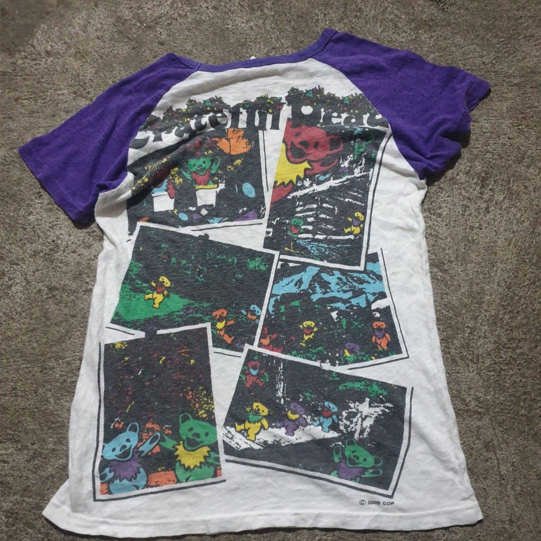 Grateful Dead Forever Raglan T-Shirt (Category: Tshirts & Polo Shirts ) located in Barotac Nuevo. Submitted by ehsherjohn27 (Listing ID 1445365830, Image 2). Description: - White raglan t-shirt with purple sleeves - Features Grateful Dead dancing bears graphic on the front - Text reads 'Grateful Dead Forever' - Back graphic shows multiple dancing bear images - Copyright 2009 GDP (tag copyright 2007) - A must-have for any Grateful Dead fan!.