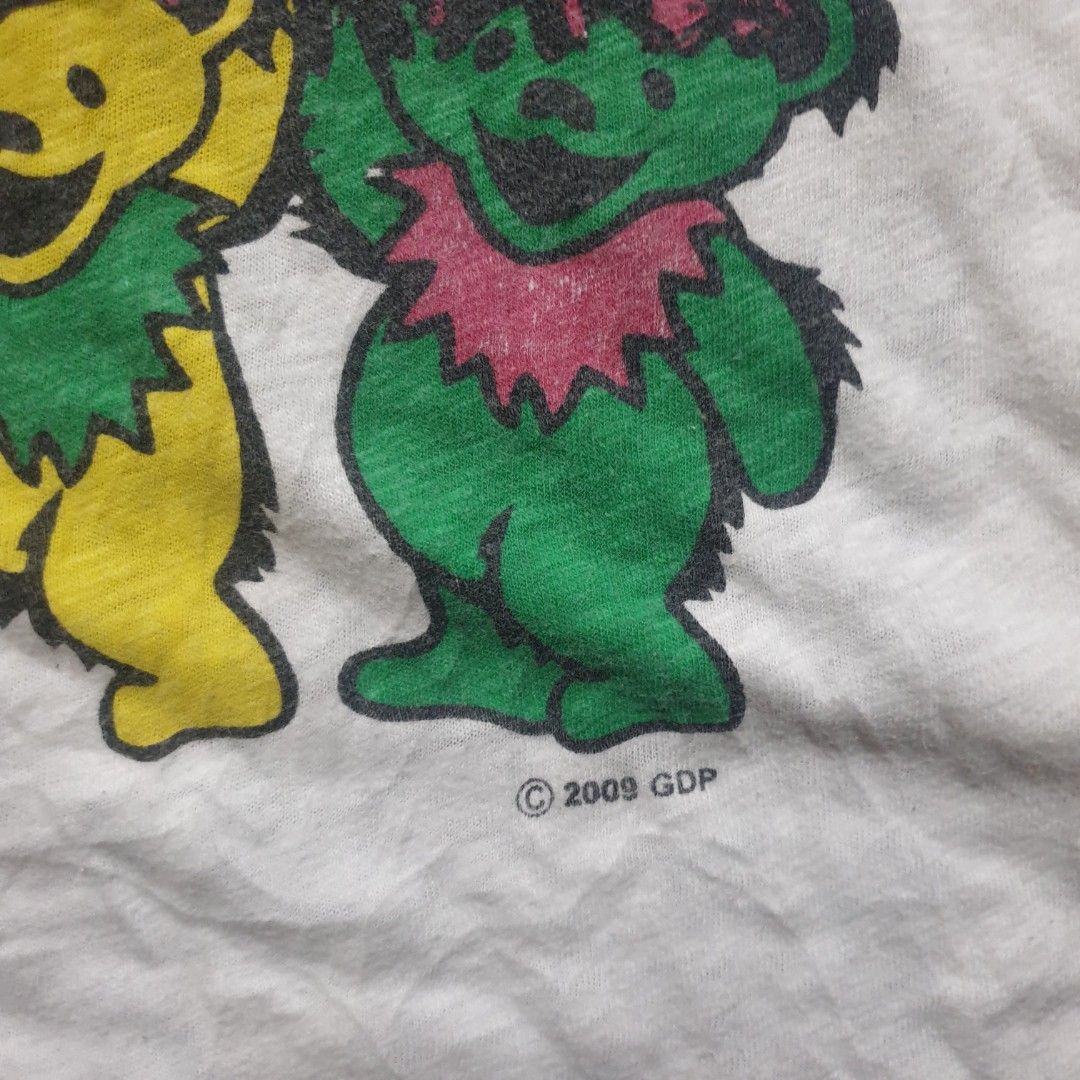 Grateful Dead Forever Raglan T-Shirt (Category: Tshirts & Polo Shirts ) located in Barotac Nuevo. Submitted by ehsherjohn27 (Listing ID 1445365830, Image 3). Description: - White raglan t-shirt with purple sleeves - Features Grateful Dead dancing bears graphic on the front - Text reads 'Grateful Dead Forever' - Back graphic shows multiple dancing bear images - Copyright 2009 GDP (tag copyright 2007) - A must-have for any Grateful Dead fan!.