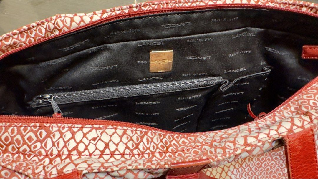 Lancel Tote Bag with Matching Pouch (Category: Luxury Bags & Wallets) located in Calamba. Submitted by doublegm (Listing ID 1445351478, Image 2). Description: - Eye-catching red and white snake print design - Genuine leather handles and trim - Interior zippered pocket for secure storage - Includes a matching pouch - Versatile for everyday errands or travel adventures.