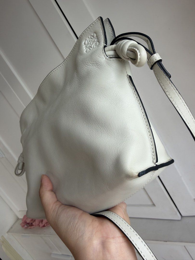 Loewe Flamenco Clutch (Category: Luxury Bags & Wallets) located in Quezon City. Submitted by shopping.eco (Listing ID 1445274337, Image 3). Description: Authentic Condition: 9/10 A few small dirt or rubs Loewe flamenco Color: off white Inclusions: dustbag, booklet and bag organizer Tomas Morato, Quezon City.