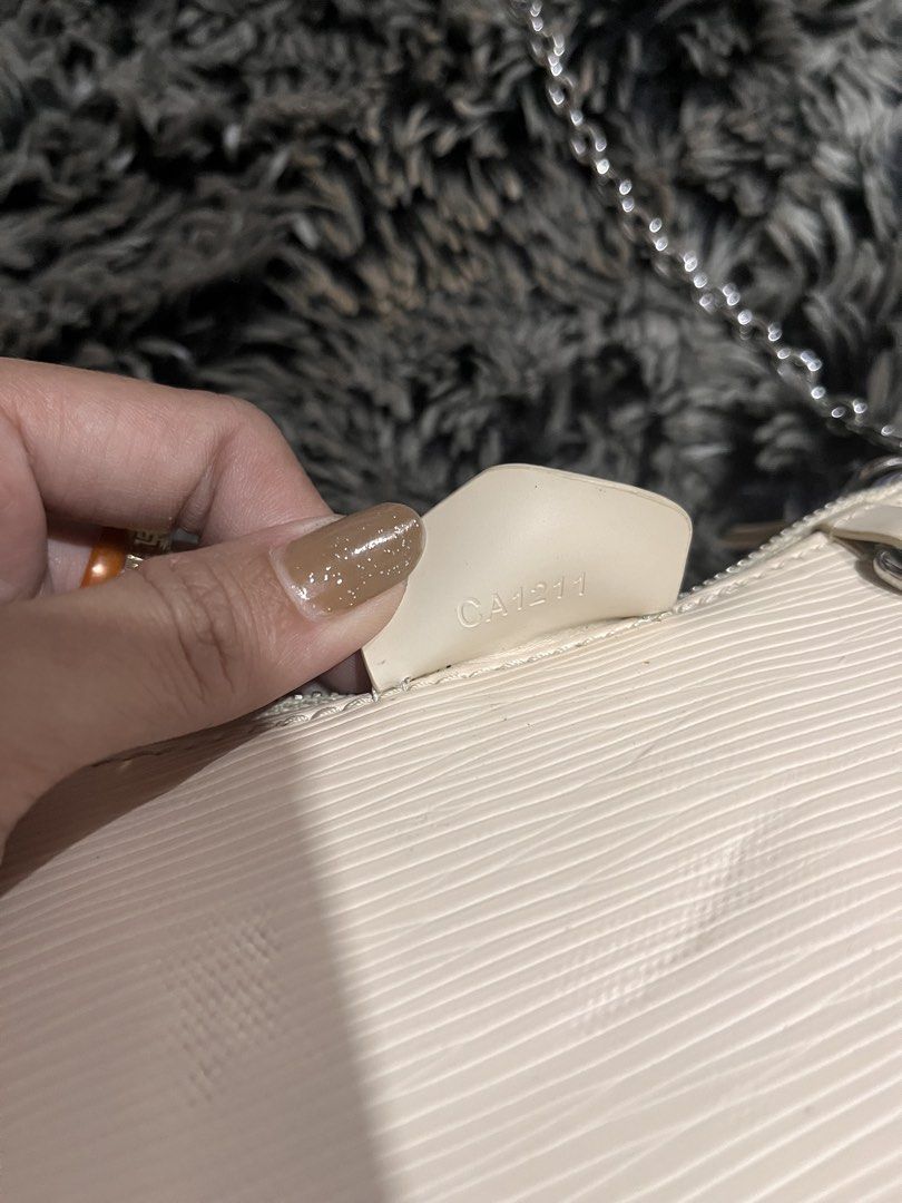 Louis Vuitton Epi Leather Pochette Accessoires Bag (Category: Luxury Bags & Wallets) located in Manila. Submitted by japanluxpallete (Listing ID 1445244534, Image 3). Description: - Authentic Louis Vuitton Pochette - Color: Cream - Material: Epi Leather - Closure: Zipper - Strap: Silver Chain - Interior: Minor marks - Exterior: Small scuff on corner - Authenticity: Made in France, Date Code CA1211.
