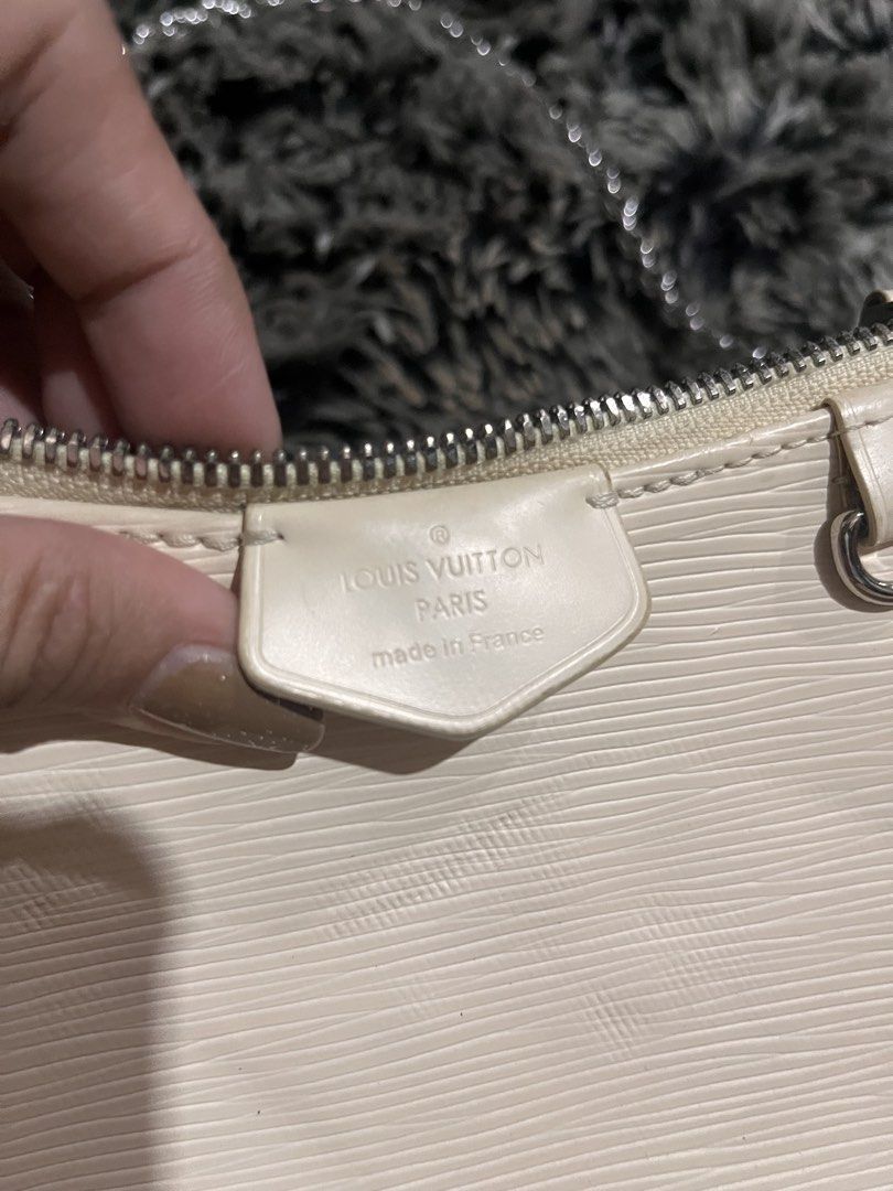 Louis Vuitton Epi Leather Pochette Accessoires Bag (Category: Luxury Bags & Wallets) located in Manila. Submitted by japanluxpallete (Listing ID 1445244534, Image 2). Description: - Authentic Louis Vuitton Pochette - Color: Cream - Material: Epi Leather - Closure: Zipper - Strap: Silver Chain - Interior: Minor marks - Exterior: Small scuff on corner - Authenticity: Made in France, Date Code CA1211.