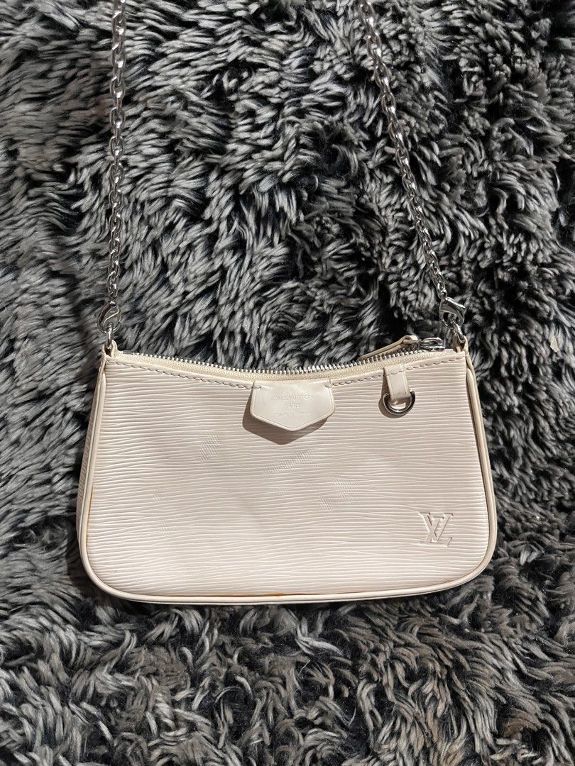 Louis Vuitton Epi Leather Pochette Accessoires Bag (Category: Luxury Bags & Wallets) located in Manila. Submitted by japanluxpallete (Listing ID 1445244534, Image 1). Description: - Authentic Louis Vuitton Pochette - Color: Cream - Material: Epi Leather - Closure: Zipper - Strap: Silver Chain - Interior: Minor marks - Exterior: Small scuff on corner - Authenticity: Made in France, Date Code CA1211.