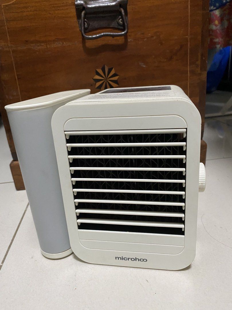 Microhoo Portable Air Cooler with Water Tank (Category: Air Conditioning and Heating) located in Quezon City. Submitted by waytodeclutter (Listing ID 1445370261, Image 1). Description: - Portable air cooler from Microhoo - Features a detachable water tank - Adjustable vents for customized airflow - Easy-to-use control knob - Convenient USB power port - Ideal for personal cooling solutions - In good working condition.