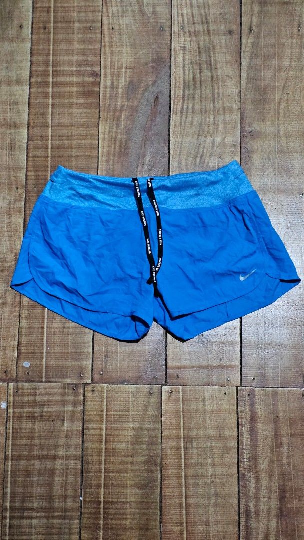 Nike Dri-FIT Blue Running Shorts (Category: Activewear) located in Kibawe. Submitted by Thrift_ni_Babac (Listing ID 1445241142, Image 1). Description: - Blue Nike running shorts - Made with Dri-FIT material for sweat-wicking - Elastic waistband with adjustable drawstring - Features the iconic Nike logo on the leg - Perfect for running, workouts, or any athletic activity - Lightweight and comfortable for maximum performance.