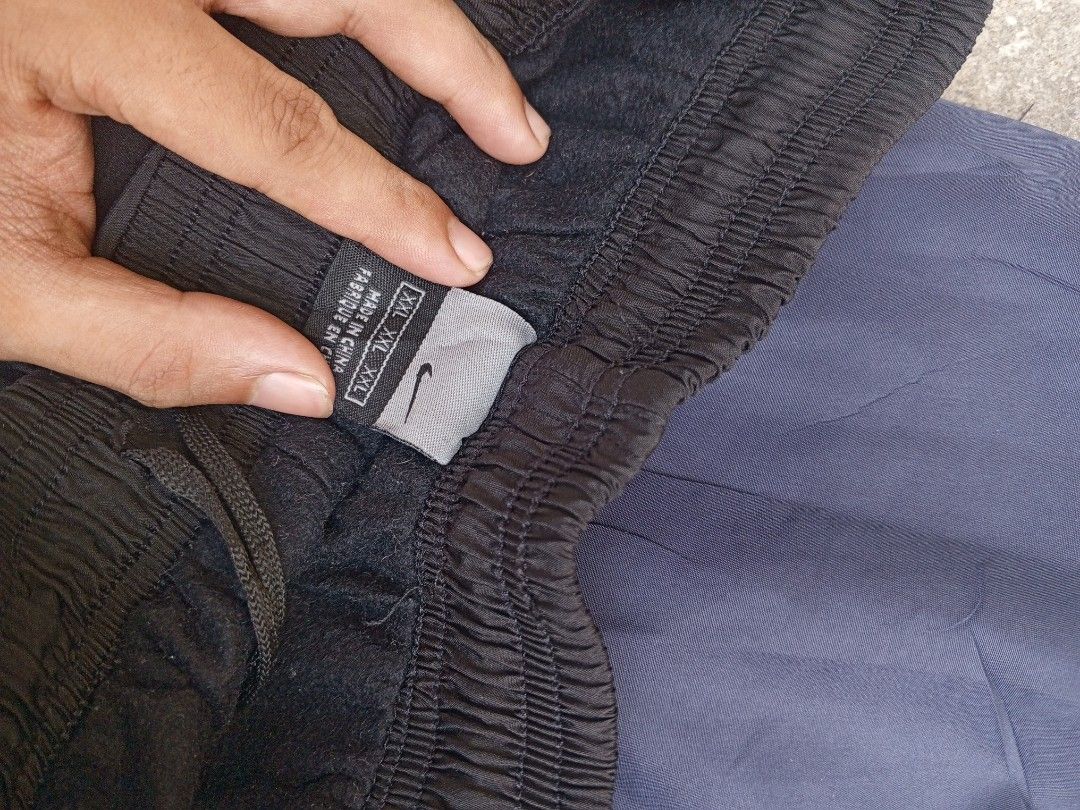 Nike Track Pants Bundle (Category: Joggers) located in Bulacan. Submitted by sentzuyu (Listing ID 1445270304, Image 3). Description: - Two pairs of Nike track pants - Colors: Navy blue with white stripes, Black with grey accents - Features: Comfortable, elastic waistband - Condition: Good - Ideal for: Sports, casual wear.