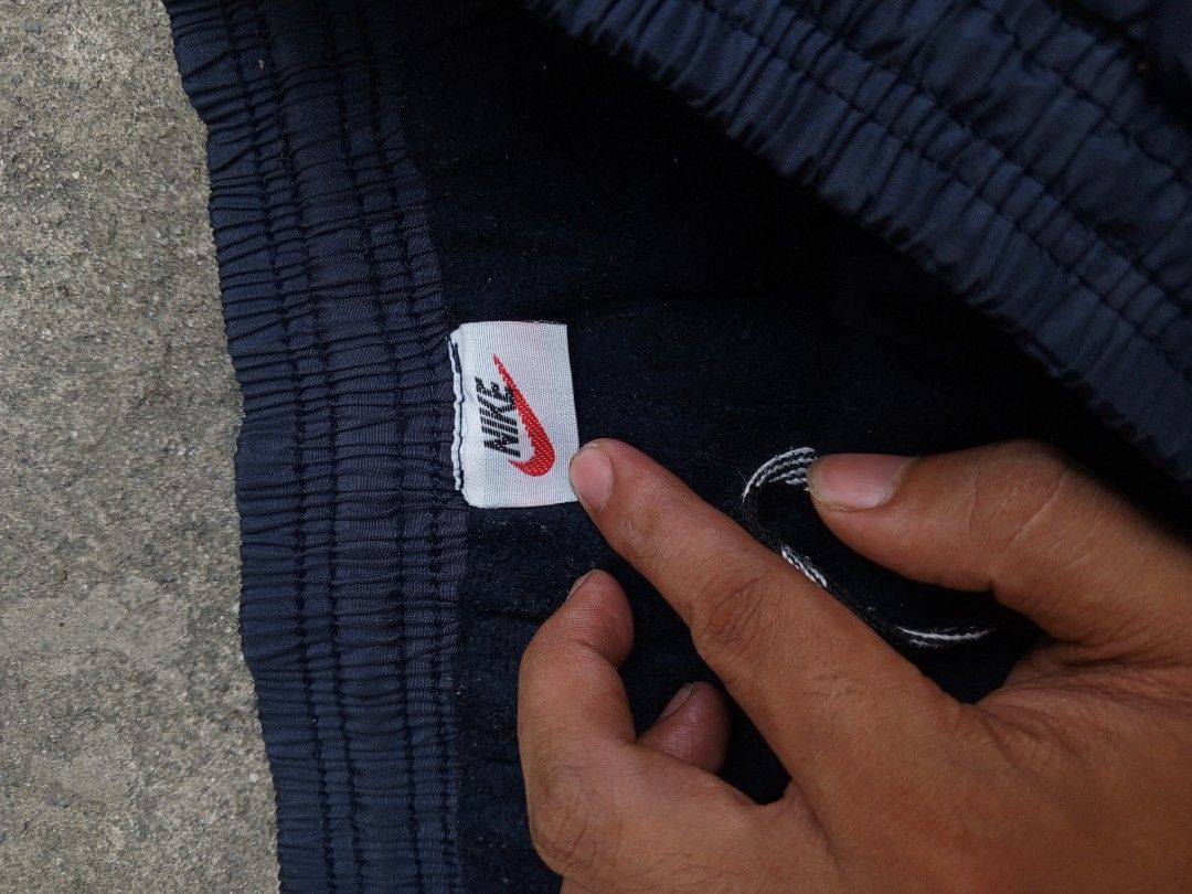 Nike Track Pants Bundle (Category: Joggers) located in Bulacan. Submitted by sentzuyu (Listing ID 1445270304, Image 2). Description: - Two pairs of Nike track pants - Colors: Navy blue with white stripes, Black with grey accents - Features: Comfortable, elastic waistband - Condition: Good - Ideal for: Sports, casual wear.