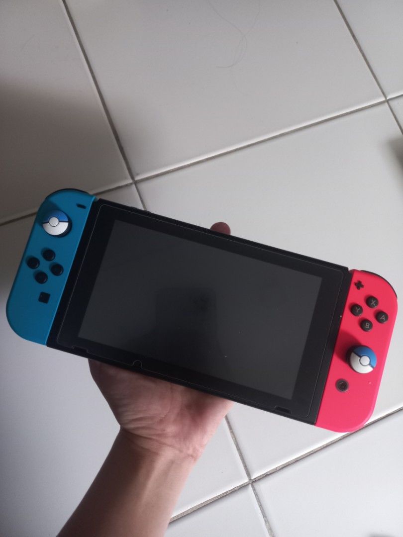 Nintendo Switch Console with Accessories (Category: Nintendo) located in Bacoor. Submitted by micca01 (Listing ID 1445253903, Image 1). Description: FOR SALE: Nintendo Switch V1 Few times palang nagamit (like mga 10 beses palang haha) inclusions indicated below: - Nintendo Switch Console - Dock - Joy-Cons (Left & Right) - Joy-Con Grip - AC Adapter - HDMI Cable - Carrying Case - Thumb Grips - All essential accessories included for immediate gaming